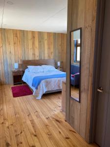 a bedroom with a large bed and a mirror at Casa de campo Matanzas in Navidad +23 photos
