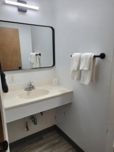 a bathroom with a sink and a mirror and towels at Lake Stop Resort in Buffalo