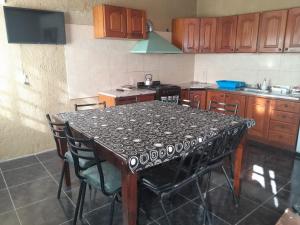 a kitchen with a table with chairs in it at Mateo y Stella in Bialet Massé