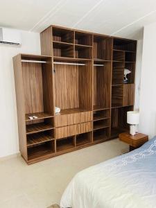 a bedroom with wooden book shelves and a bed at Lovely 2 bedroom 2 bathroom condo in Cancún