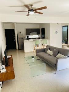 a living room with a couch and a ceiling fan at Lovely 2 bedroom 2 bathroom condo in Cancún