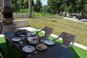 a blue table with food on it with chairs at Стаи за гости Мартинови in Zlatograd