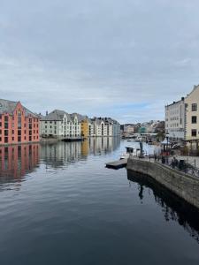 a view of a river with buildings and houses at Eidsviklaaven in Ålesund