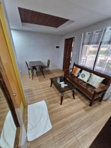 a living room with a couch and a table at Panglao Kalikasan Resort in Panglao Island