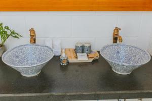 two blue and white sinks sitting on top of a counter at Perolas Villas Resort - Ke Ga Bay in Phan Thiet