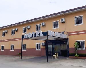 a hotel with a sign in front of it at Valentine Hotel Angeles City managed by Cocotel in Angeles