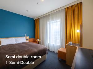 a hotel room with a bed and a window at Kansai Airport Washington Hotel in Izumi-Sano