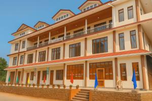 a large building with flags in front of it at Hotel Kailash in Harsil