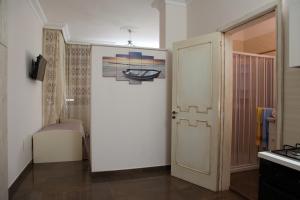 a hallway with a door and a bed in a room at Palazzo Primavera in Porto Cesareo
