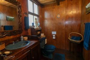 a bathroom with a sink and a toilet and a mirror at Cabaña Vista al Cielo - Cabañas Terrazul in Pinal de Amoles +25 photos
