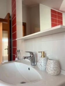 a bathroom sink with a mirror and a white sink at Apartment Danijela in Vodice +10 photos