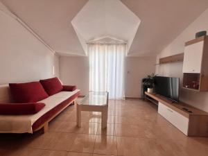 a living room with a couch and a tv at Apartment Danijela in Vodice