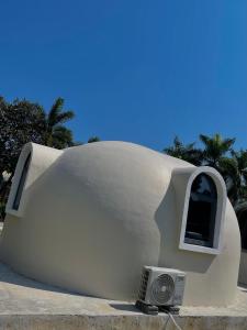 a small house with a window and a speaker at Timor Lodge in Dili