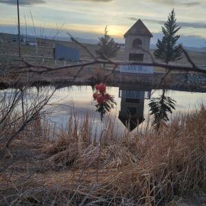 a reflection of a church in a body of water at Lake Stop Resort in Buffalo +14 photos