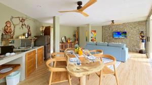 a kitchen and living room with a table and chairs at Aqualina Villa, Carbana Lodge, A Hidden Gem in Koh Samui