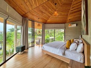 a bedroom with a large bed with a wooden ceiling at Aqualina Villa, Carbana Lodge, A Hidden Gem in Koh Samui +87 photos