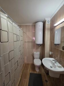 a bathroom with a white toilet and a sink at Horizon Katrina Apartments - Sea line & Beach Access in Sveti Vlas
