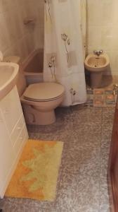 a bathroom with a toilet and a sink at La Casina de Llanes in Llanes
