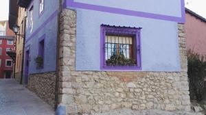 a building with a window with a purple at La Casina de Llanes in Llanes
