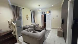 a living room with two couches and a table at Puncak azoul villa in Cinengangirang