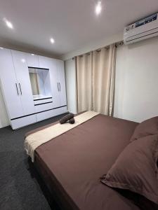 a bedroom with a large bed and white cabinets at 3-Bedroom family-ready flat in Namadi Heights in Suva +5 photos