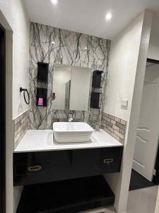 a bathroom with a sink and a mirror at 3-Bedroom family-ready flat in Namadi Heights in Suva