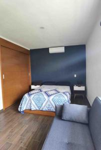 a bedroom with a bed and a couch at Casa de Campo Lake Shore Jocotepec in San Cristóbal Zapotitlán +89 photos