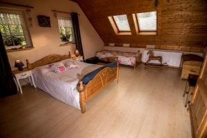 a bedroom with a large bed in a room at Chalupa Kamenná Horka in Krásná Lípa