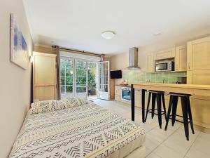a kitchen with two beds in a room at Studio au calme, piscine, animaux admis, climatisation, Var - FR-1-779-17 in Callian
