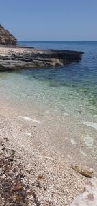 a beach with rocks and the water at Casa Alyssa in Monte SantʼAngelo