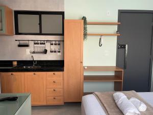 a small kitchen with a sink and a bed at Casa Mar III in João Pessoa