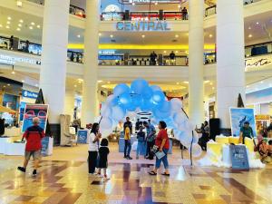 a group of people standing in a mall with blue balloons at Luxury Stay By Times Square Kuala Lumpur in Kuala Lumpur +45 photos