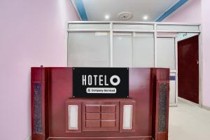 a hotel sign sitting on top of a red door at Hotel O Behror in Neemrana