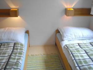 two beds sitting next to each other in a room at Fewo Schlosspark Grubhof in Sankt Martin bei Lofer