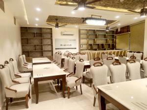 a dining room with tables and chairs in a room at The Monark Inn in Sandīla