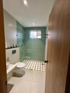 a bathroom with a toilet and a glass shower at Three Oceans Resort in Kanyakumari +17 photos