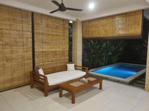 a room with a bed and a swimming pool at Umah Dewi Private Villa in Ubud