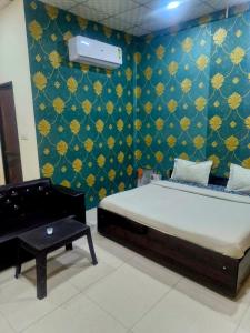 a bedroom with a bed and a piano in a room at SAMURAI farm & RESORT in Jaipur