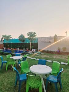 a group of tables and chairs in the grass at SAMURAI farm & RESORT in Jaipur