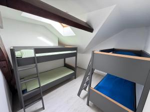 a bunk room with two bunk beds and a ladder at L'Horizon Silencieux Loft in Lucquy