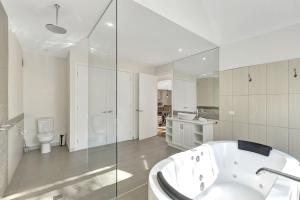 a white bathroom with a tub and a toilet at Next to Bliss Luxury Guesthouse in Bright +11 photos