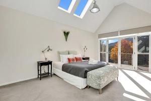 a white bedroom with a bed and a window at Next to Bliss Luxury Guesthouse in Bright