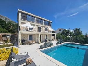 a villa with a swimming pool and a house at Stone Villa at the Vrelo in Dobra Voda