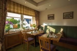 a restaurant with two tables and a window at Hotel Haus Andrea in Winterberg