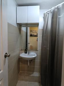 a bathroom with a sink and a mirror at 1bedroom one oasis condo fullyfurnished in Davao City