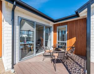 a patio with a table and chairs on a deck at Supernova B -2 Bedrooms in Lake Tekapo
