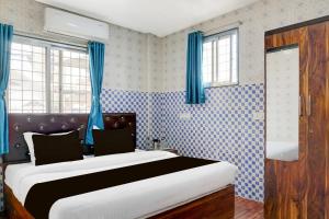 Ένα ή περισσότερα κρεβάτια σε δωμάτιο στο Hotel O Corporate Stay