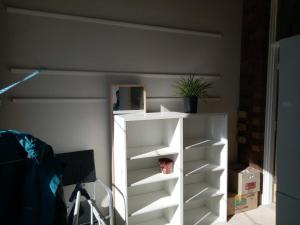 a white book shelf with a potted plant on it at 410 Kangaroo ground 15 , 20 people restaurant in Kangaroo Ground