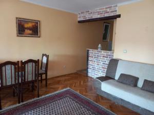 a living room with a couch and a brick fireplace at Exit NS in Novi Sad