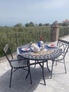 a table with two chairs and a tea set on it at Villa Annamaria in Torino di Sangro